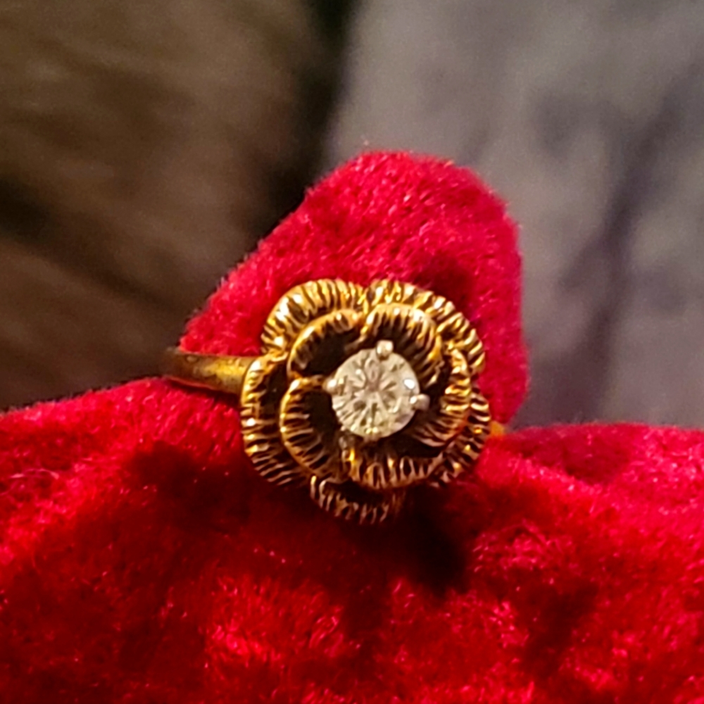 Vintage gold diamond solitaire pinky ring in a rose setting.